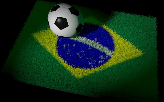 alfombra de la bandera de brasil con un balon de futbol encima